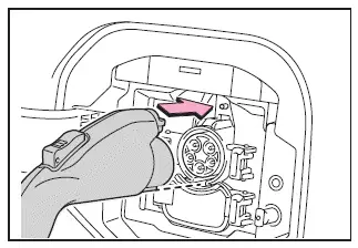 Subaru Solterra charging connector fully inserted and locked into inlet