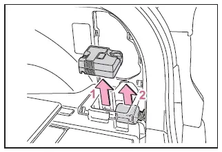 Subaru Solterra tire repair kit removal showing compressor and sealant bottle