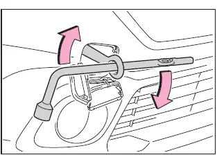 Subaru Solterra tightening towing eyelet with wrench for secure attachment